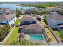 Aerial view of a beautiful home with a screened-in pool and a view of the lake at 11852 Lake Lucaya Dr, Riverview, FL 33579