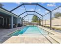Relaxing screened-in pool area with brick pavers and a view of the backyard at 11852 Lake Lucaya Dr, Riverview, FL 33579