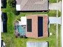 Overhead view of the home with solar panels, screened pool, and spacious backyard at 1575 Wicklow Dr, Palm Harbor, FL 34684