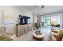 Bright living room showcasing an entertainment center, accent chairs, and access to the outdoor space at 19475 Bristol Wood Pl, Brooksville, FL 34601