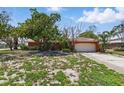 Charming single-story home featuring a two-car garage and tile roof at 2001 Iowa Ne Ave, St Petersburg, FL 33703
