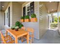 Cozy porch with outdoor dining area and charming flower boxes at 20113 Bending Creek Pl, Tampa, FL 33647