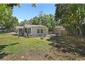 Spacious fenced-in backyard with a hammock, perfect for relaxation, and a small deck area at 249 41St Ne Ave, St Petersburg, FL 33703