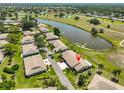 This is an aerial view of a home on a large lot with a lake in the backyard at 2509 Locksley St # 237, Sun City Center, FL 33573