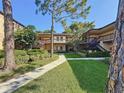 Attractive condo complex featuring lush landscaping and inviting walkways at 2693 Sabal Springs Cir # 206, Clearwater, FL 33761
