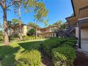 Charming condo complex showcasing manicured lawns and inviting walkways at 2693 Sabal Springs Cir # 206, Clearwater, FL 33761