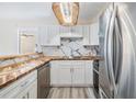 Bright kitchen featuring white cabinets, wood counters, stainless steel appliances, and marble backsplash at 2901 26Th W St # 317, Bradenton, FL 34205