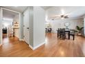 Inviting dining room showcasing wood floors, a modern ceiling fan, and an open layout with views of the living area at 34 Hickory Ln, Safety Harbor, FL 34695