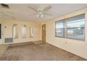 Inviting living room featuring neutral walls, carpet flooring, and natural light from large windows at 3706 Cambridge St, New Port Richey, FL 34652