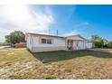 Quaint single-Gathering home with a well-lit front porch, single car garage, and small outdoor seating area at 3706 Cambridge St, New Port Richey, FL 34652