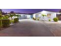 Contemporary one-story home with a spacious driveway, modern garage door, manicured shrubs, and inviting blue front door at 4644 Bay Crest Dr, Tampa, FL 33615