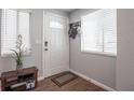 Inviting entryway featuring ceramic tile flooring, a stylish shoe rack, and a contemporary front door at 4702 Stonepointe Pl, Tampa, FL 33634