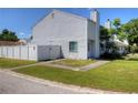 A townhome featuring a well-manicured lawn and classic siding, complete with inviting curb appeal at 4702 Stonepointe Pl, Tampa, FL 33634