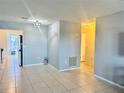 Inviting living room area showcasing the neutral paint, tile flooring, and easy access to the kitchen at 5501 80Th N St # 509, St Petersburg, FL 33709