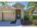 Inviting front entrance showcasing a stylish blue door and well-maintained landscaping at 6203 34Th E Ct, Ellenton, FL 34222
