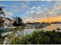 Tranquil water view of a waterfront home with dock, lush landscaping, and serene coastal charm at 712 Sunset Cv, Madeira Beach, FL 33708