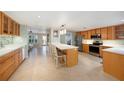 Spacious kitchen featuring wood cabinets, tiled floors, stainless steel appliances, and a large center island at 785 5Th S St, Safety Harbor, FL 34695
