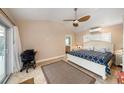 Inviting bedroom boasts a ceiling fan, exterior access, a neutral color palette, and an en-suite bathroom at 785 5Th S St, Safety Harbor, FL 34695