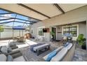 The covered patio features comfortable seating, an umbrella-covered dining table, and a play area at 8226 Summer Brook Ct, Land O Lakes, FL 34638
