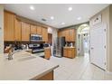 Spacious kitchen featuring stainless steel appliances, tile flooring, and ample cabinet space at 8429 Hunters Fork Loop, Ruskin, FL 33573