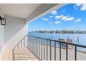 Balcony with aluminum railings overlooking the water and a view of the beautiful blue sky at 9901 1St E St # D, Treasure Island, FL 33706