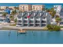 Waterfront townhouse featuring balconies, a private dock, and a stunning view of the intercoastal waterway at 9901 1St E St # D, Treasure Island, FL 33706