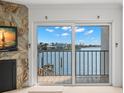 Living room with a sliding glass door to a balcony that provides beautiful views of the intercoastal waterway at 9901 1St E St # D, Treasure Island, FL 33706
