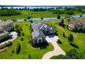Aerial view of house showing beautifully landscaped yard overlooking lake at 10509 Broadland Pass, Thonotosassa, FL 33592