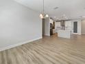 Spacious dining area with views to the kitchen which is equipped with white cabinetry and stainless steel appliances at 11443 Apple Tree Cir, Bradenton, FL 34211
