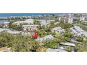 Aerial view of community featuring lush landscaping, complex and water views at 11450 Harbor Way # 5008, Largo, FL 33774