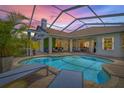 Relaxing screened-in pool area with lounge chairs and lush landscaping, perfect for outdoor entertaining and leisure at 1220 Darlington Oak Ne Cir, St Petersburg, FL 33703