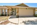 Home's front entrance with stone accents, covered porch, and attached two-car garage at 12532 115Th St, Largo, FL 33778