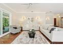 Bright living room with hardwood floors, plush rug, and neutral decor at 15324 Sherwood Forest Dr, Tampa, FL 33647