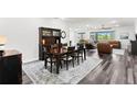 Open concept living space and dining room with hardwood floors and modern furnishings at 19204 Briarbrook Dr, Tampa, FL 33647