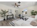 Comfortable living room with a white sectional, modern decor, and a ceiling fan at 1974 N Betty Ln, Clearwater, FL 33755