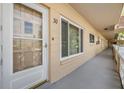 Exterior entrance showcasing door number 30, a window, and an outdoor hallway lined with units at 2310 Denmark St # 30, Clearwater, FL 33763