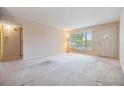 An open-concept living room with large window and a doorway leading into another room at 2310 Denmark St # 30, Clearwater, FL 33763