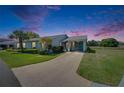 Inviting single-story home featuring meticulous landscaping and a convenient covered carport at 2313 Grenoble Pl # 2313, Sun City Center, FL 33573