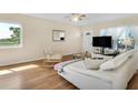 Bright living room with hard wood floors, modern furnishings, and ample natural light at 2458 Columbia Dr E # 84, Clearwater, FL 33763
