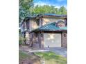 Charming townhome with an attached garage, brick accents, and mature landscaping at 2663 Sequoia Ter # 2663, Palm Harbor, FL 34683