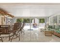 Enclosed sunroom boasts tile floors and access to the backyard patio, offering a tranquil indoor-outdoor space at 28628 Twinbrook # Ln, Wesley Chapel, FL 33543