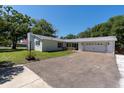 Well-kept home featuring a spacious driveway, attached two-car garage, and a beautifully landscaped yard at 315 Oakwood Blvd, Oldsmar, FL 34677