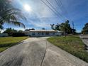 Well-kept single-story house with a long driveway and mature landscaping at 4031 Bay Ne St, St Petersburg, FL 33703