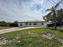 Inviting single-story home featuring a metal roof and a lush front yard at 4031 Bay Ne St, St Petersburg, FL 33703