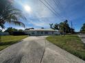 Well-kept single-story house with a long driveway and mature landscaping at 4031 Bay Ne St, St Petersburg, FL 33703