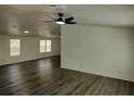 Comfortable living room with updated floors and ceiling fan at 4102 Fox Ridge Blvd, Wesley Chapel, FL 33543