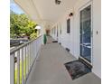 Long exterior view of the entrance to the apartments with secured doors and an airy patio at 500 Glennes Ln # 205, Dunedin, FL 34698