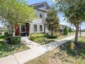 Charming two-story home with landscaped yard and inviting walkway on a sunny day at 5714 Colony Glen Rd, Lithia, FL 33547