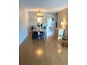 Spacious dining room with laminate floors, and stylish chandelier at 5955 30Th S Ave # 108, Gulfport, FL 33707