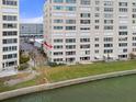 Beautiful waterfront condo building with well-maintained lawn and direct water access, offering serene outdoor living at 5980 Shore S Blvd # 312, Gulfport, FL 33707